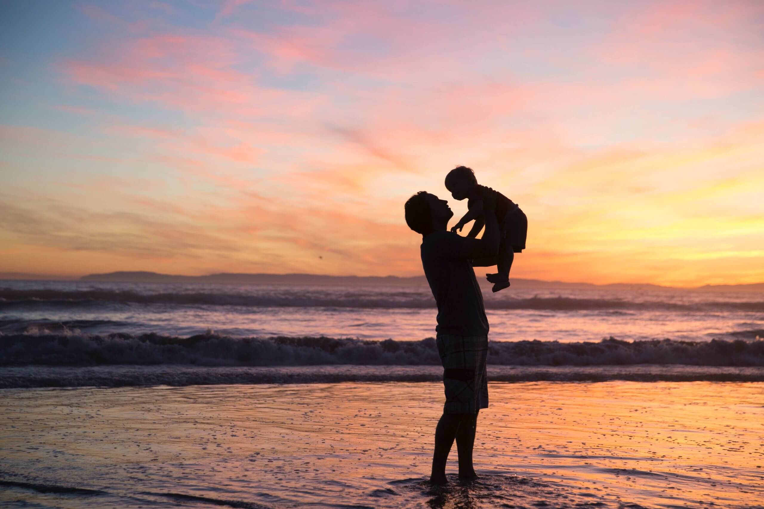 Parenting Lifting Child On Beach